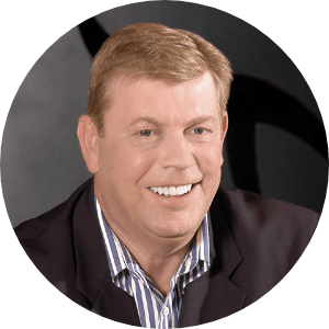 Man in a suit with a big smile.